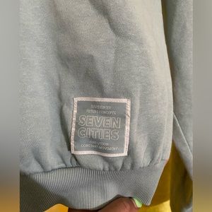 a light teal sweater